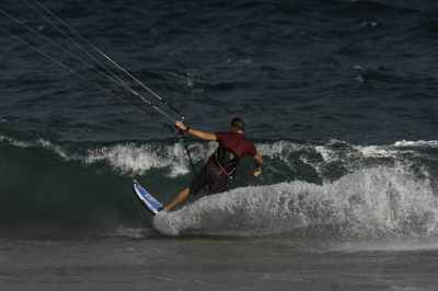 Kitesurfer setting up a forehand snap in the wave pocket