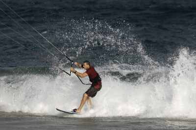 Kitesurfer pivoting off the lip during a re-entry